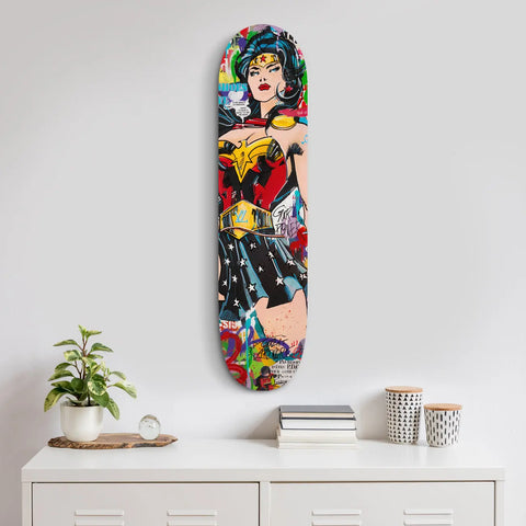 Colorful skateboard deck featuring a pop art-style Wonder Woman illustration.