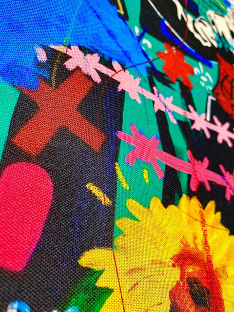 Colorful fabric with vibrant floral and abstract patterns.