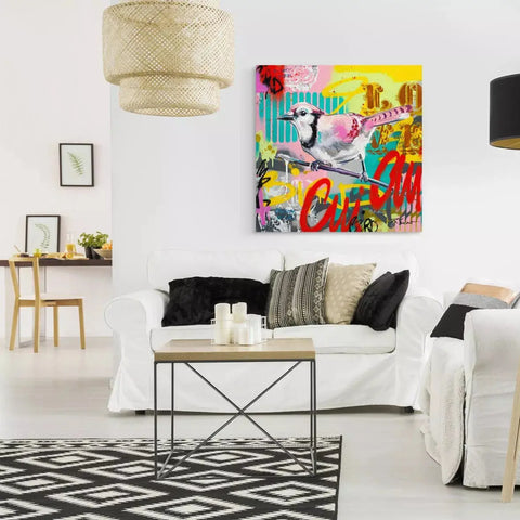A living room with white walls and a large painting on the wall