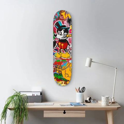 Colorful skateboard deck with cartoon character artwork mounted on a wall.