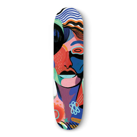 Colorful skateboard deck featuring an abstract face design with vibrant patterns.
