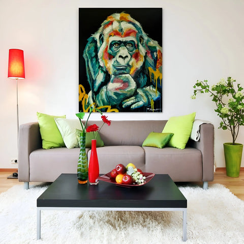 A contemporary living room with a colorful gorilla painting above a taupe sofa.