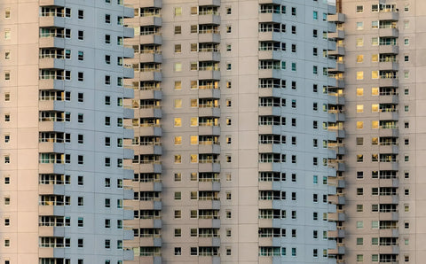 A tall building with many windows and bales