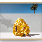 A vibrant yellow, ruffled garment with a voluminous, layered design.