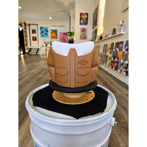 Decorative figure resembling a torso wearing a tan military-style jacket with a white collar.