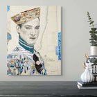 Collage portrait canvas featuring a man in a beret and turtleneck, composed of layered newspaper clippings and map fragments with blue accents on an off-white background.