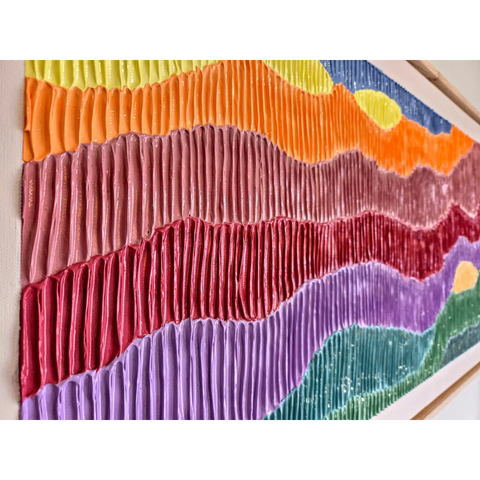 Colorful textile art piece with wavy, pleated fabric strips in various hues arranged horizontally.