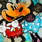 Mickey mouse and minnie mouse are standing next to each other