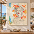 A framed mixed-media artwork featuring a woman sketch with vibrant orange goldfish on an old puerto de aniun map on aluminium