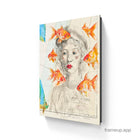 A framed canvas print titled fish eyes featuring a watercolor portrait of a woman with curly hair and goldfish on an old map background