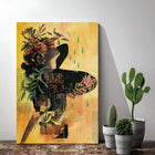Artistic canvas print featuring a silhouette filled with floral and botanical elements against a yellow background.