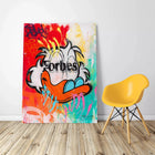 A colorful painting on a wall with a yellow chair