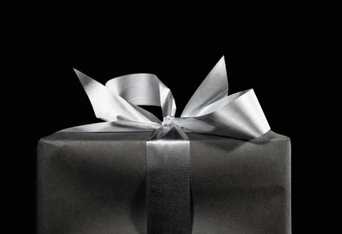 Gift box wrapped with an elegant ribbon bow.