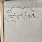 A framed painting of a dog on a wall