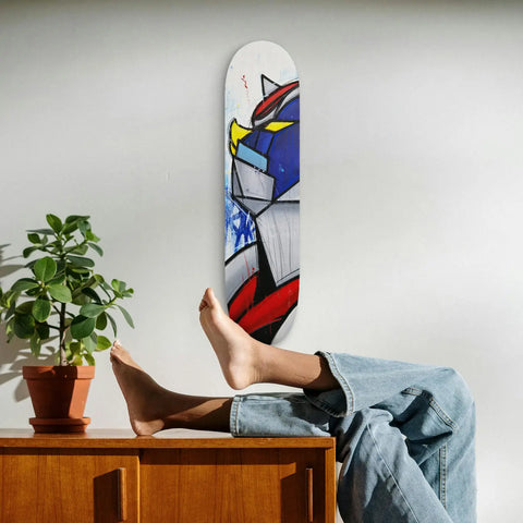 Skateboard deck featuring an abstract geometric design in red, blue, and yellow colors.