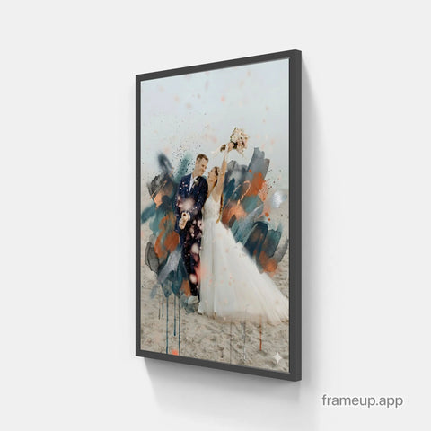 A framed wedding photograph with a modern black frame, featuring the couple in their bridal attire against an abstract watercolor background of teal and orange splashes.