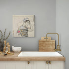 A framed collage artwork featuring a stylized male figure in a cap, rendered with black ink and text fragments on an off-white background.