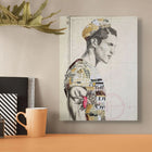 A mixed-media collage canvas featuring a stylized male profile with layered paper and text elements in muted tones, accented by a pink rose tattoo design.
