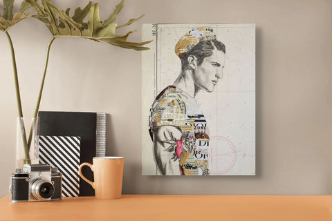 A mixed-media collage canvas featuring a stylized male profile with layered paper and text elements in muted tones, accented by a pink rose tattoo design.