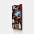 A framed print of a woman with a colorful face and a red background