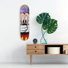 Skateboard deck painted with a colorful cartoon character design.