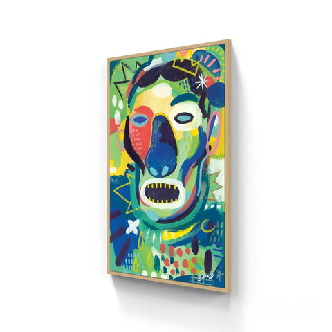 A vibrant, abstract painting of a face with bold colors and expressive brushstrokes, set in a light wooden frame.