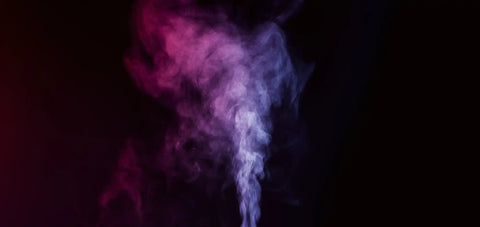 Swirling plume of colorful smoke against a dark background.