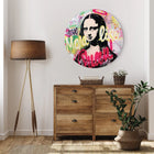 A wall mounted on the wall of a room with a wooden dresser and a painting of a woman