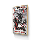 Framed abstract artwork featuring black, white, and red elements with text fragments visible.