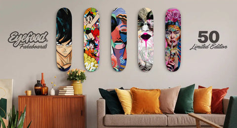 A set of five decorative skateboard decks featuring various artistic designs.