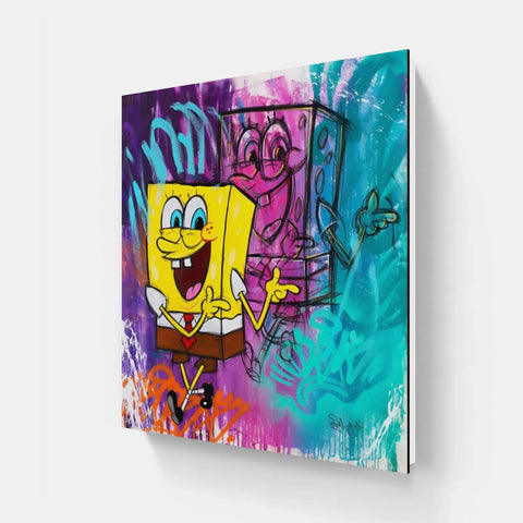 A close up of a spongebob painting on a wall with graffiti