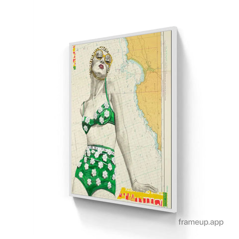 A framed vintage-style illustration of a woman in green floral bikini on a nautical map print in st yves limited edition aluminium frame