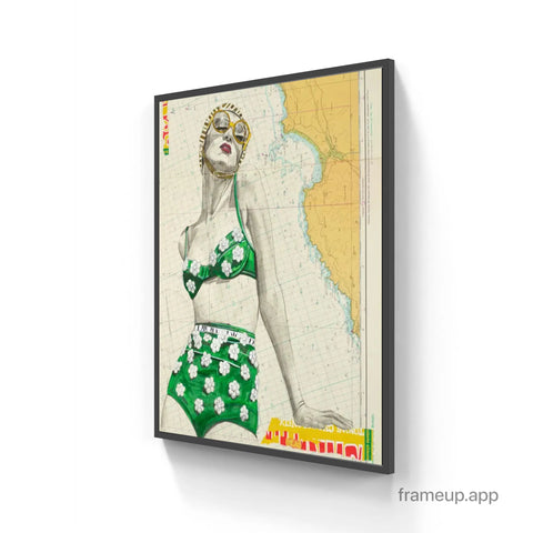 A framed vintage-style poster of a woman in a green floral bikini with gold-rimmed sunglasses in st Yves limited edition aluminium