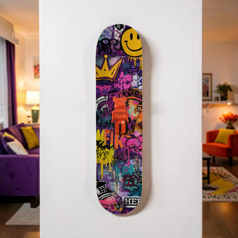 Vibrant purple skateboard deck adorned with colorful graffiti art and a central orange bear figurine.
