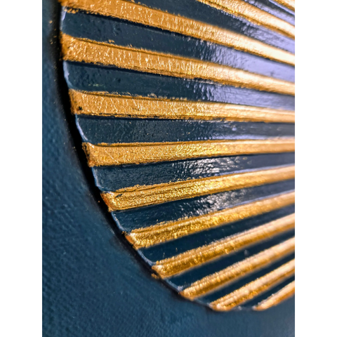 Decorative fan-like object with alternating gold and navy blue ridged segments.