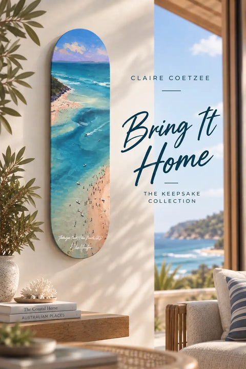 A vertically oriented skateboard deck wall art featuring a vibrant beach scene with turquoise waters, sandy shores, and scattered people under a partly cloudy sky.