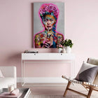 A pink wall with a painting of a woman in a pink dress