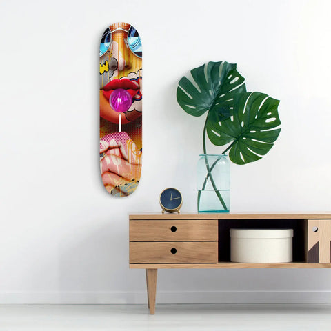 Colorful skateboard deck with vibrant pop art-style imagery of lips and facial features.